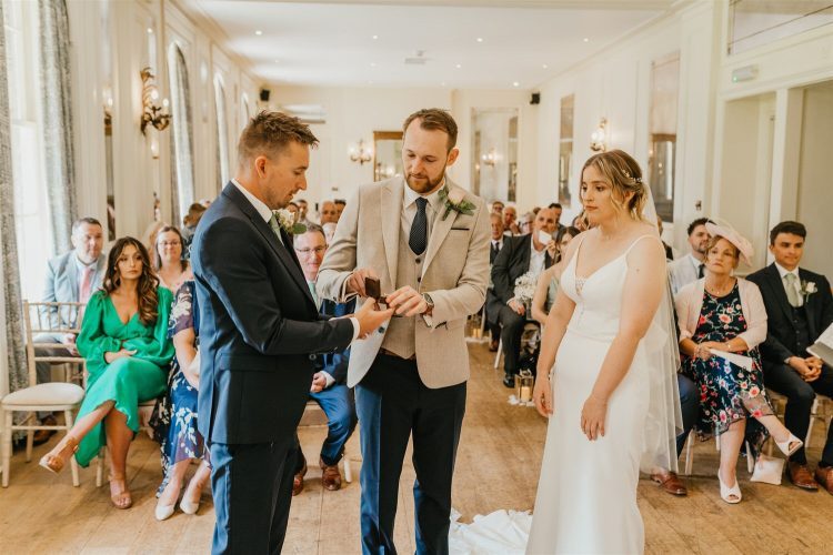 bride and groom exchange rings during wedding ceremony at hotel du vin tunbridge wells