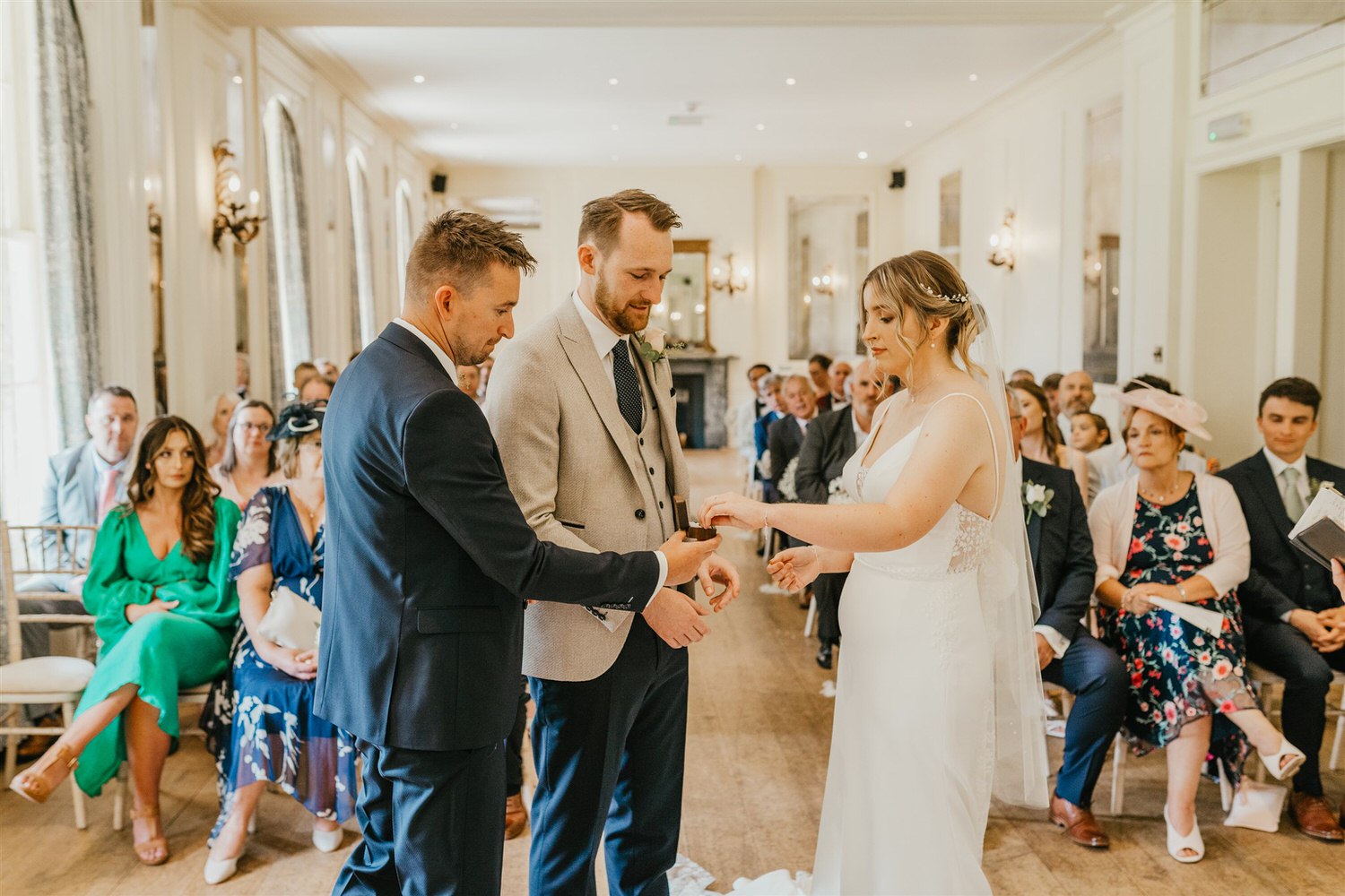 bride and groom exchange rings during wedding ceremony at hotel du vin tunbridge wells