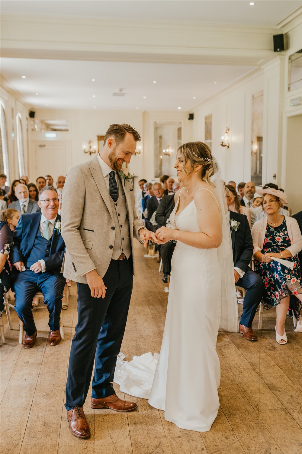 bride and groom exchange rings during wedding ceremony at hotel du vin tunbridge wells