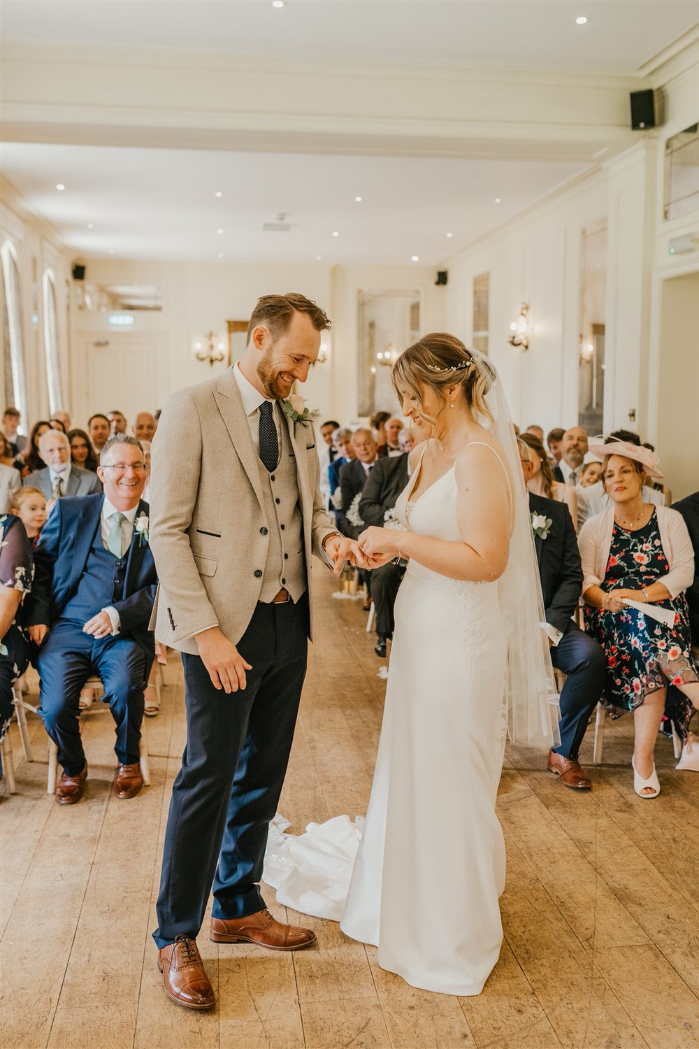 bride and groom exchange rings during wedding ceremony at hotel du vin tunbridge wells
