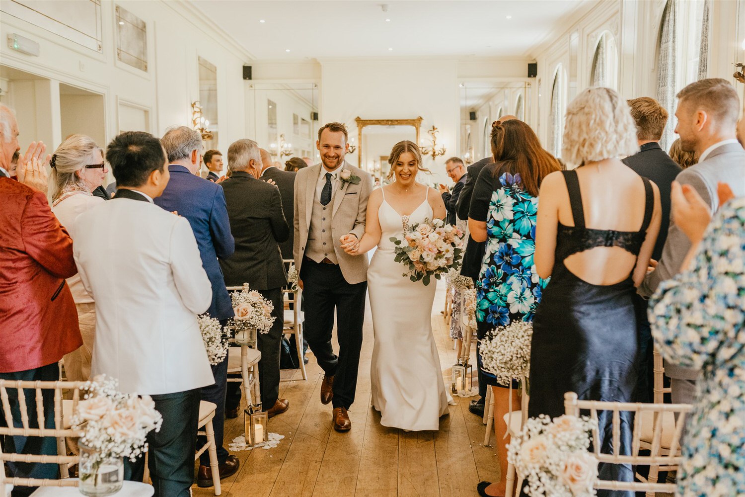 bride and groom walking back up the aisle at hotel du vin wedding ceremony