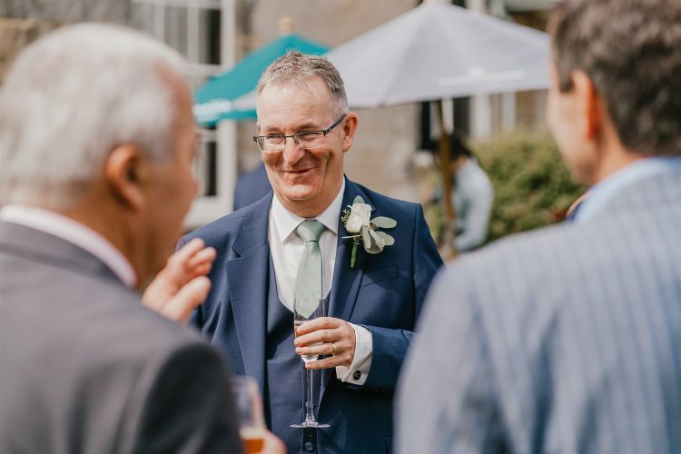 candid guest portraits during drinks reception in the gardens at hotel du vin tunbridge wells wedding