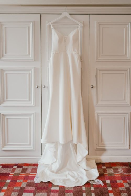 wedding dress hung on wardrobe