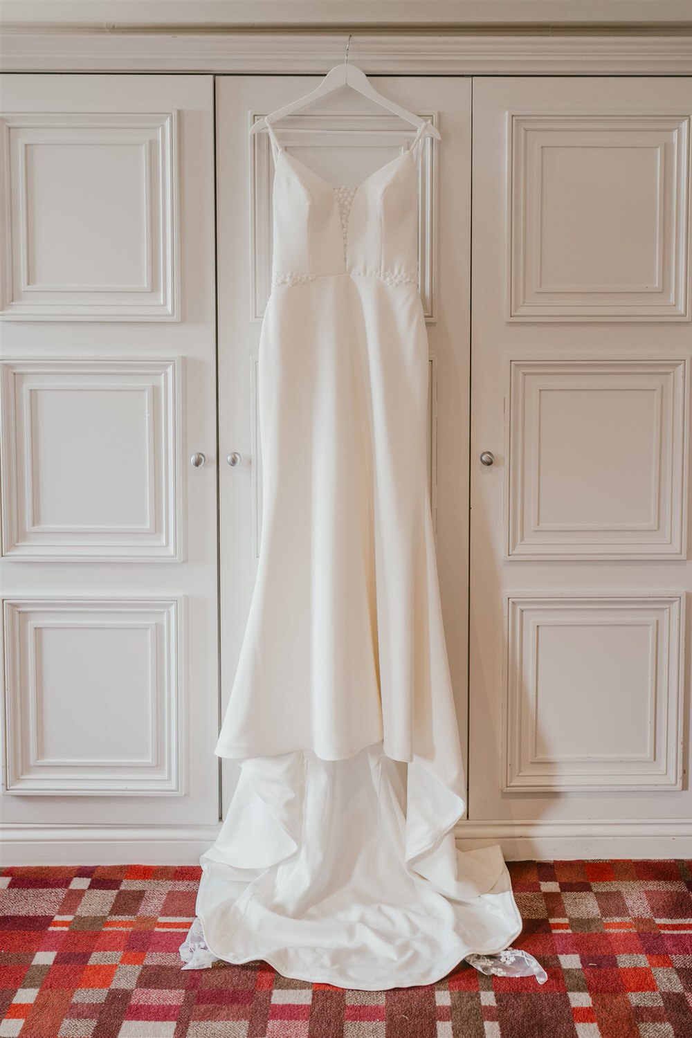 wedding dress hung on wardrobe