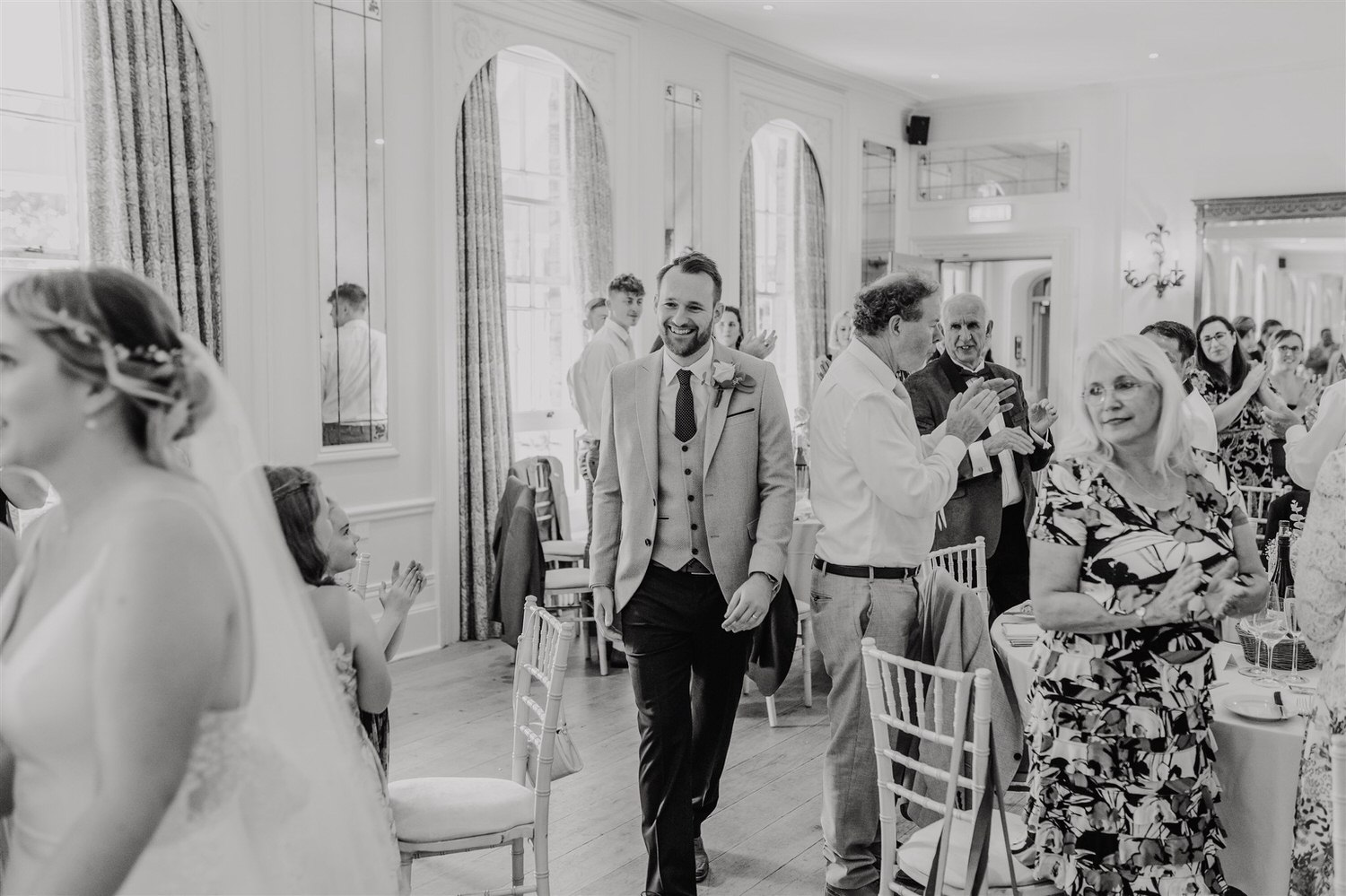 black and white photo of bride and groom entrance in the ballroom at hotel du vin tunbridge wells wedding