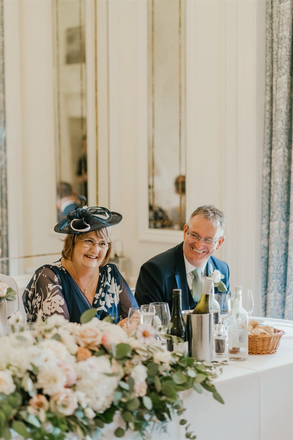 groom's parents laugh during speeches in the ballroom at hotel du vin tunbridge wells wedding