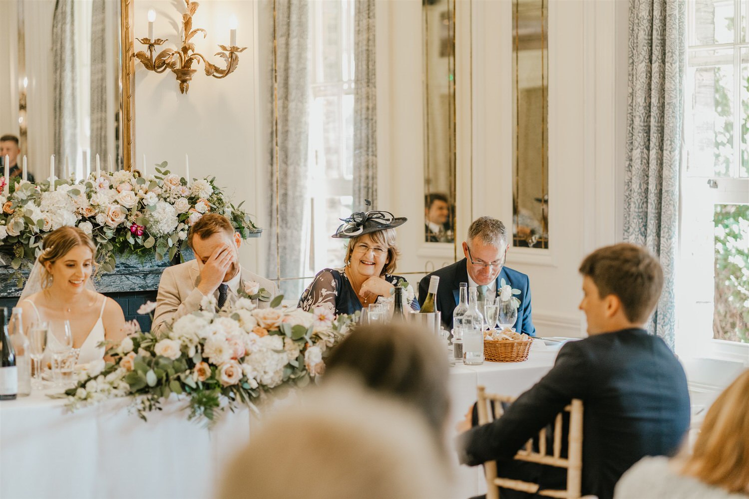 guests laugh during speeches in the ballroom at hotel du vin tunbridge wells wedding