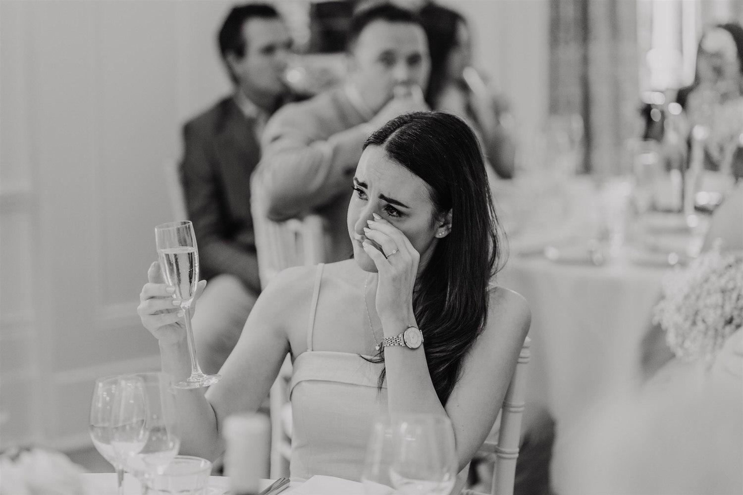 black and white photo of emotional guest toasting during groom's speech