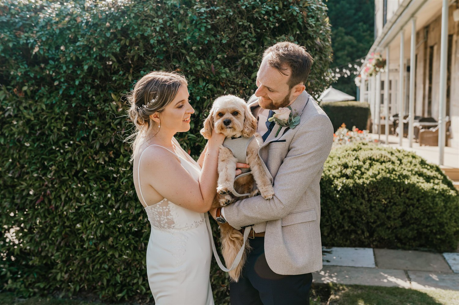 bride and groom hold their dog during portraits at hotel du vin tunbridge wells wedding