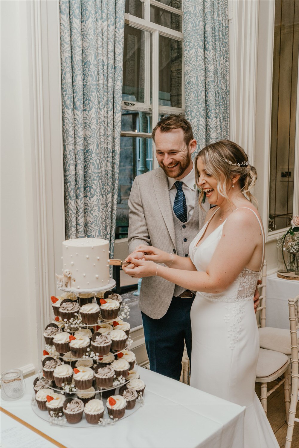 bride and groom cutting cake in ballroom at hotel du vin tunbridge wells