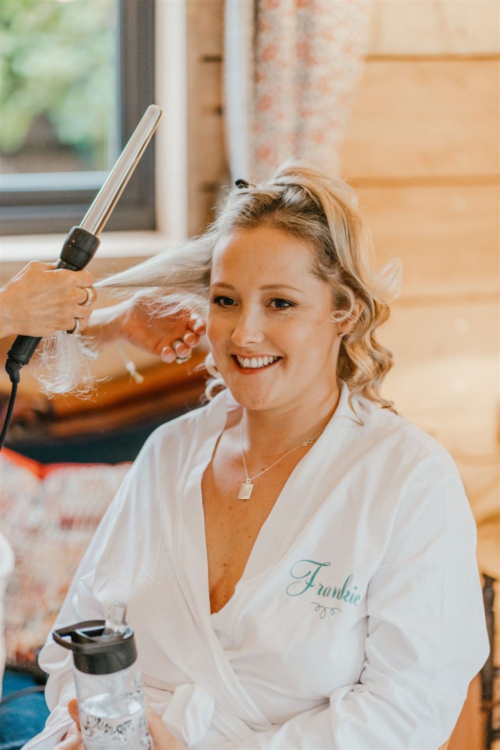 bride getting her hair done on her wedding morning