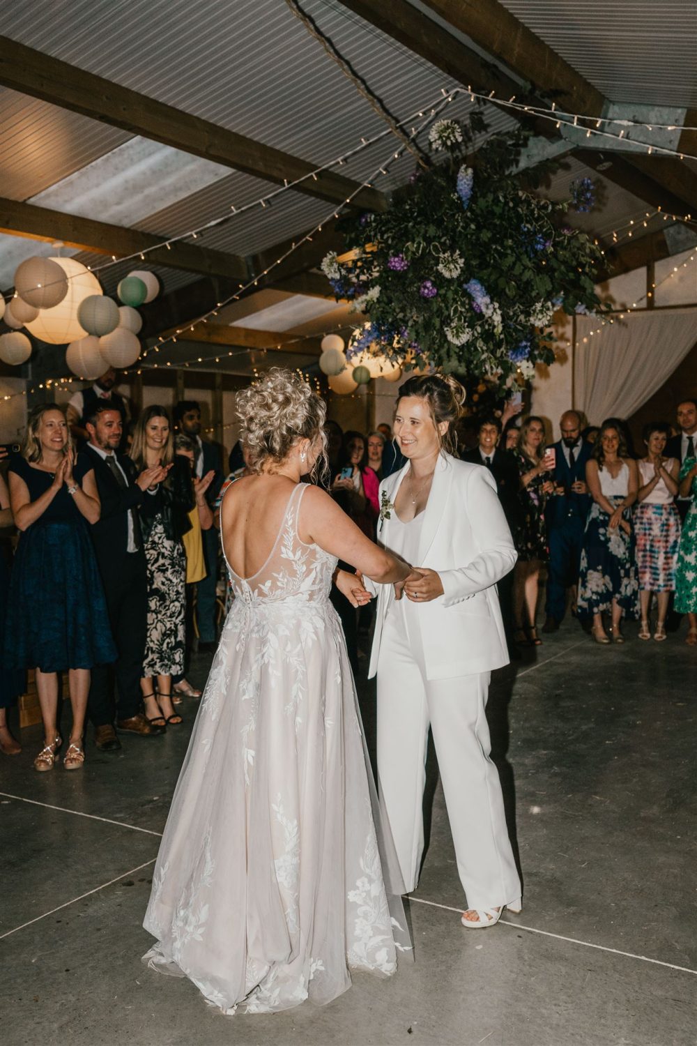 two brides having their first dance at diy wedding venue acorn barn in oxfordshire