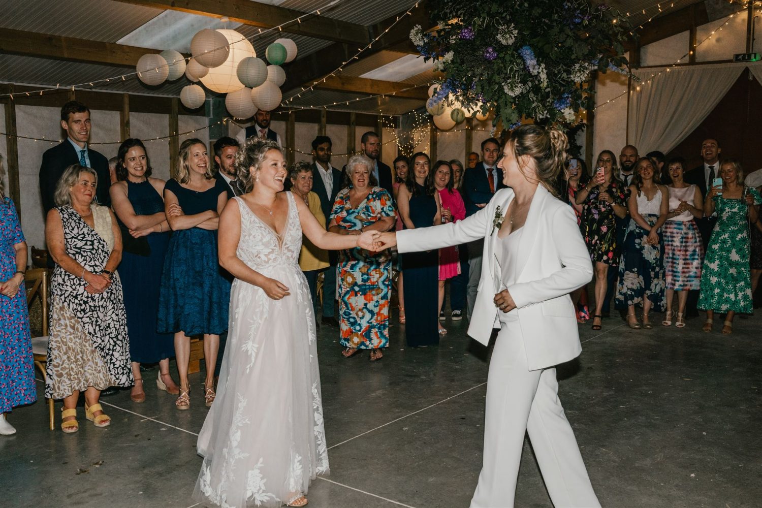 two brides having their first dance at diy wedding venue acorn barn in oxfordshire
