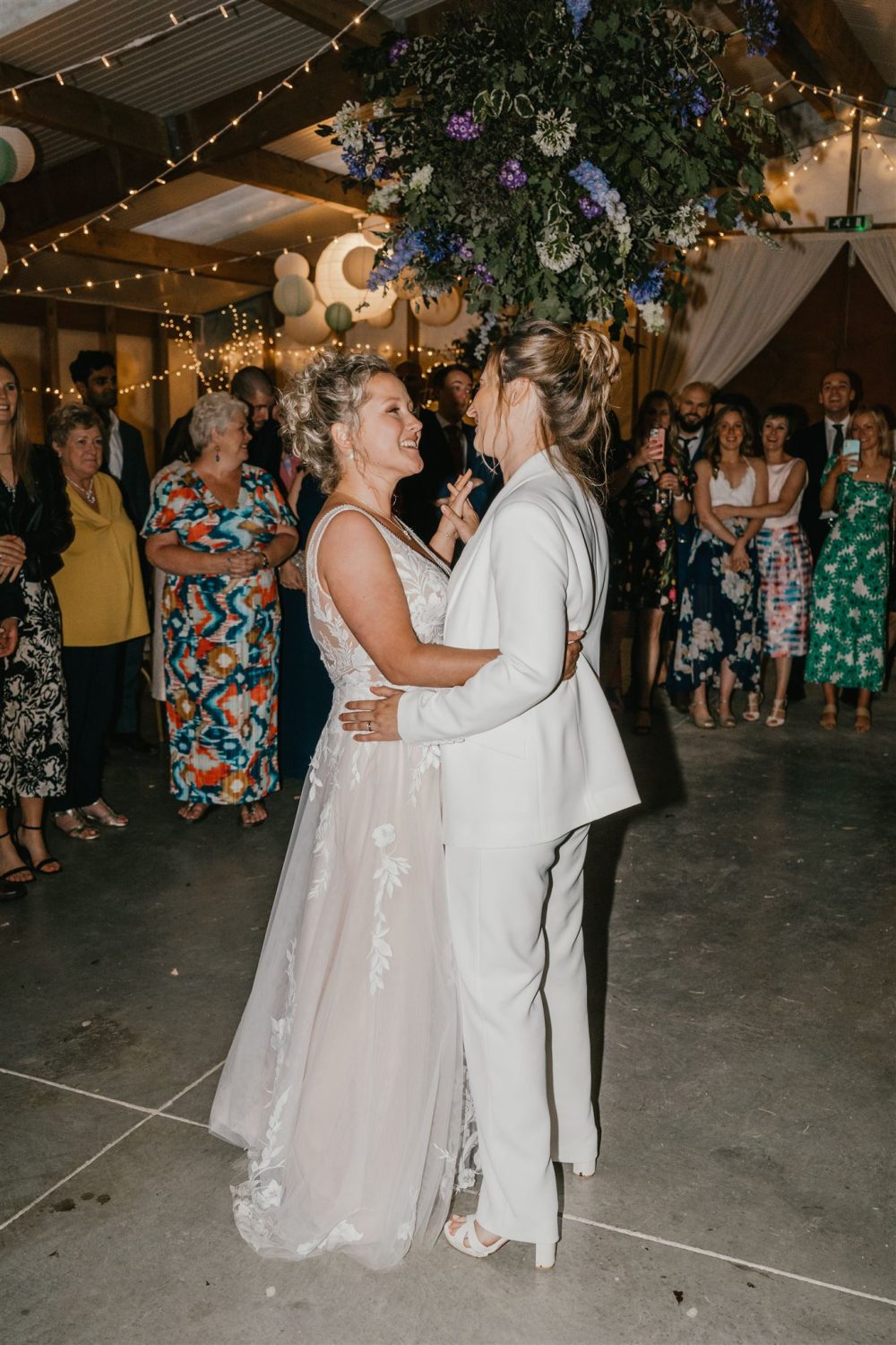 two brides having their first dance at diy wedding venue acorn barn in oxfordshire
