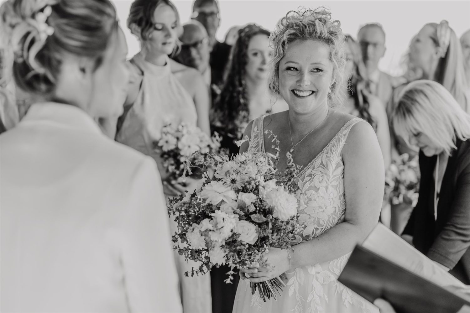 black and white photo of bride during outdoor wedding ceremony at acorn barn wedding venue in oxfordshire