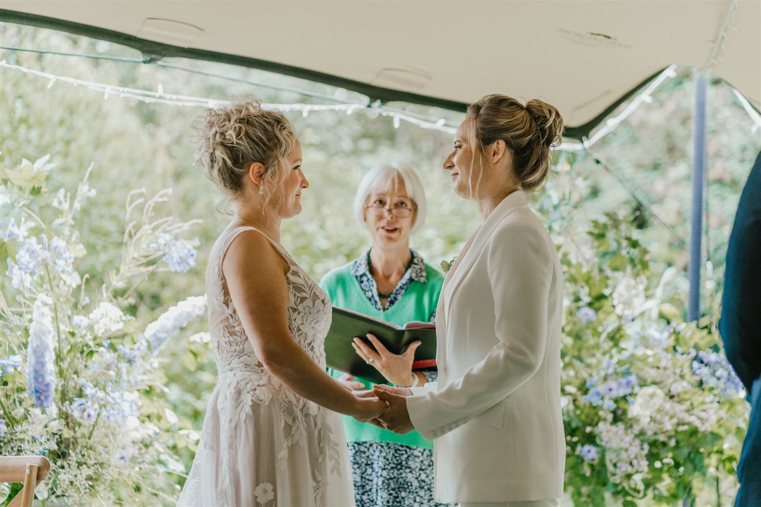 brides say their vows to each other during garden ceremony at acorn barn wedding venue in oxfordshire