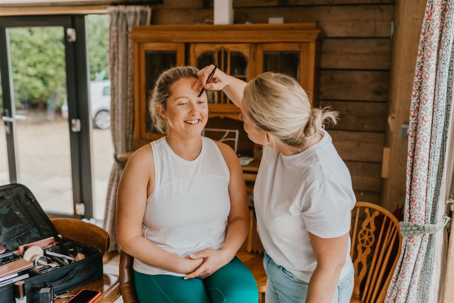 bride getting her makeup done on her wedding morning