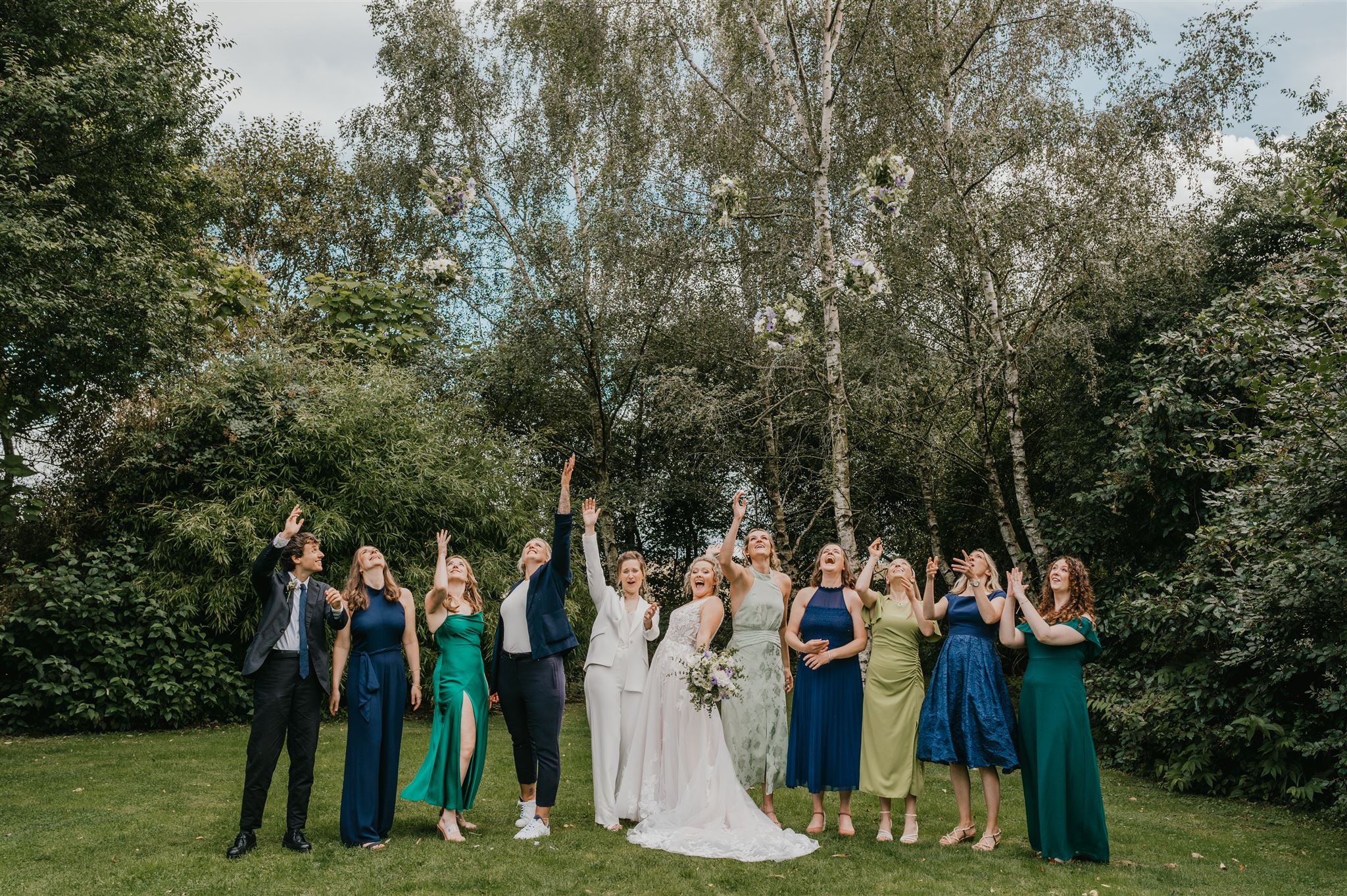 bridal party bouquet toss at acorn barn wedding venue in oxfordshire