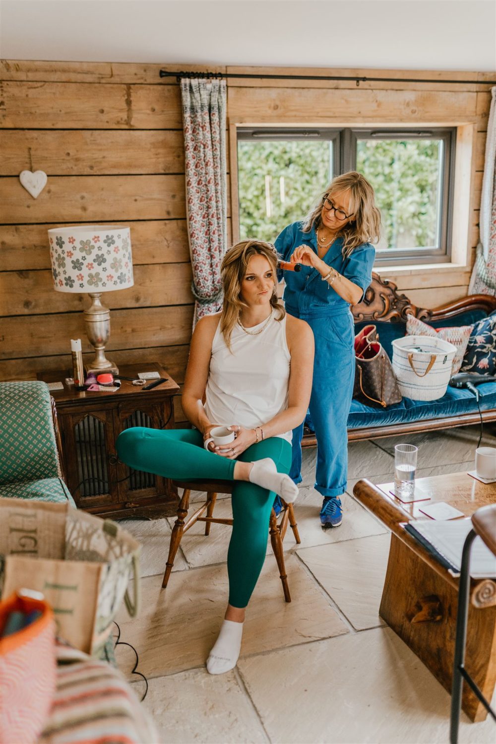 bridesmaid getting her hair done on the wedding morning