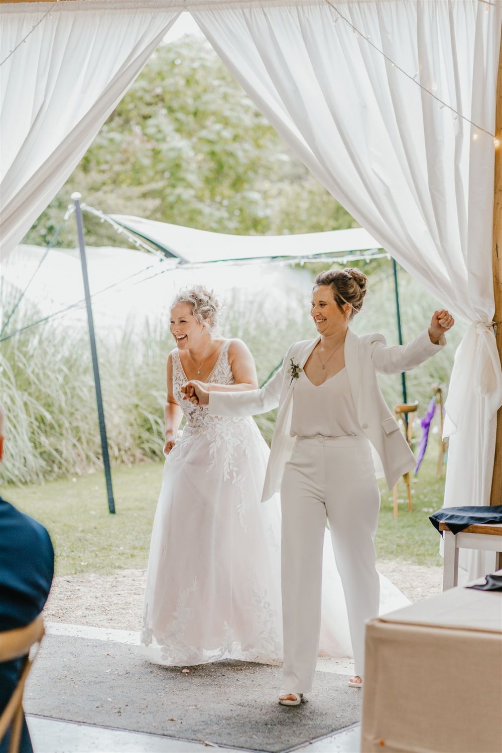 brides make grand entrance into wedding breakfast at acorn barn wedding venue