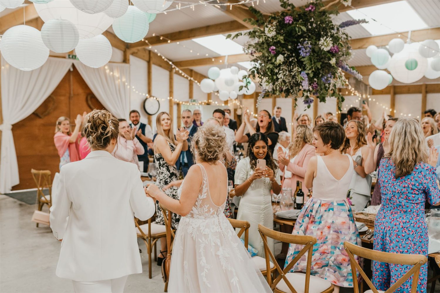 guests welcome brides at acorn barn wedding venue