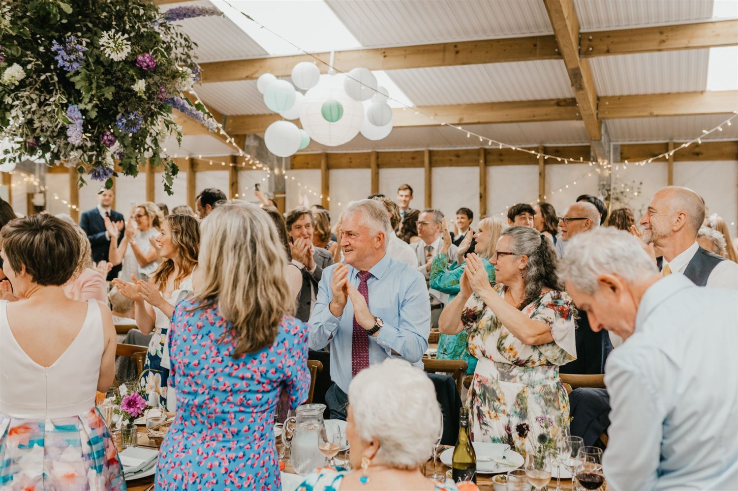 guests welcome brides at acorn barn wedding venue