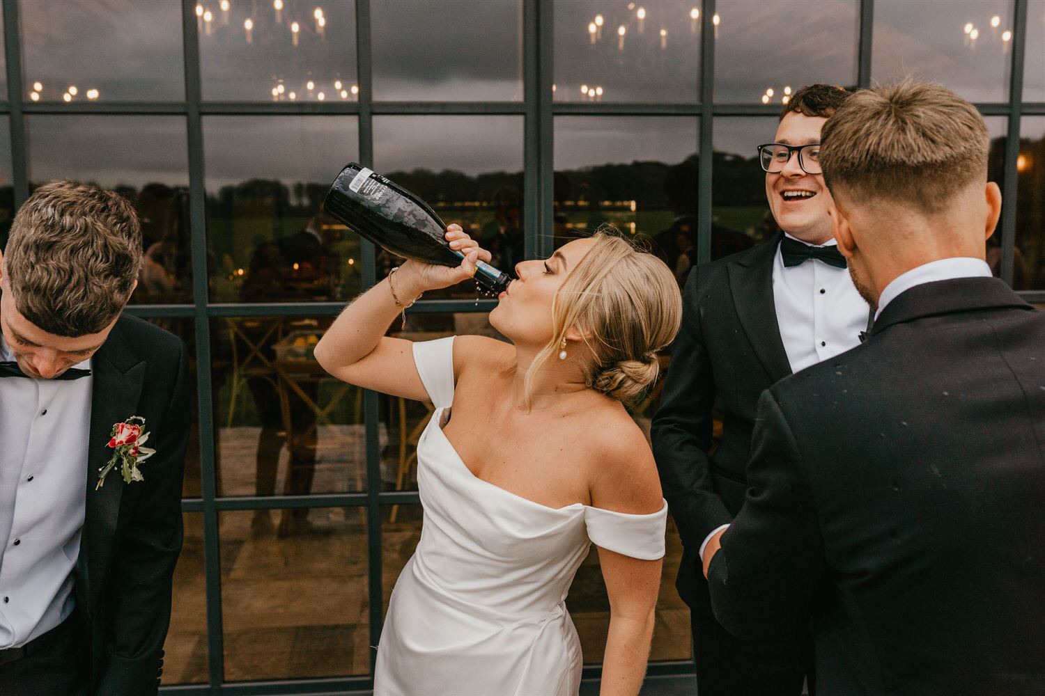 bride drinking champagne from the bottle