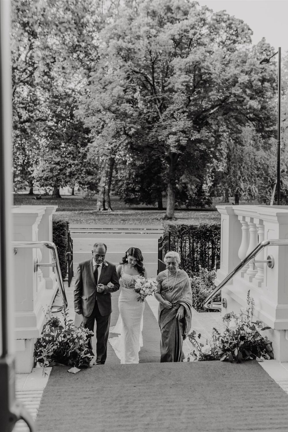 black and white photo of bride's entrance to wedding ceremony in the loggia at mandarin oriental hyde park luxury wedding venue in london