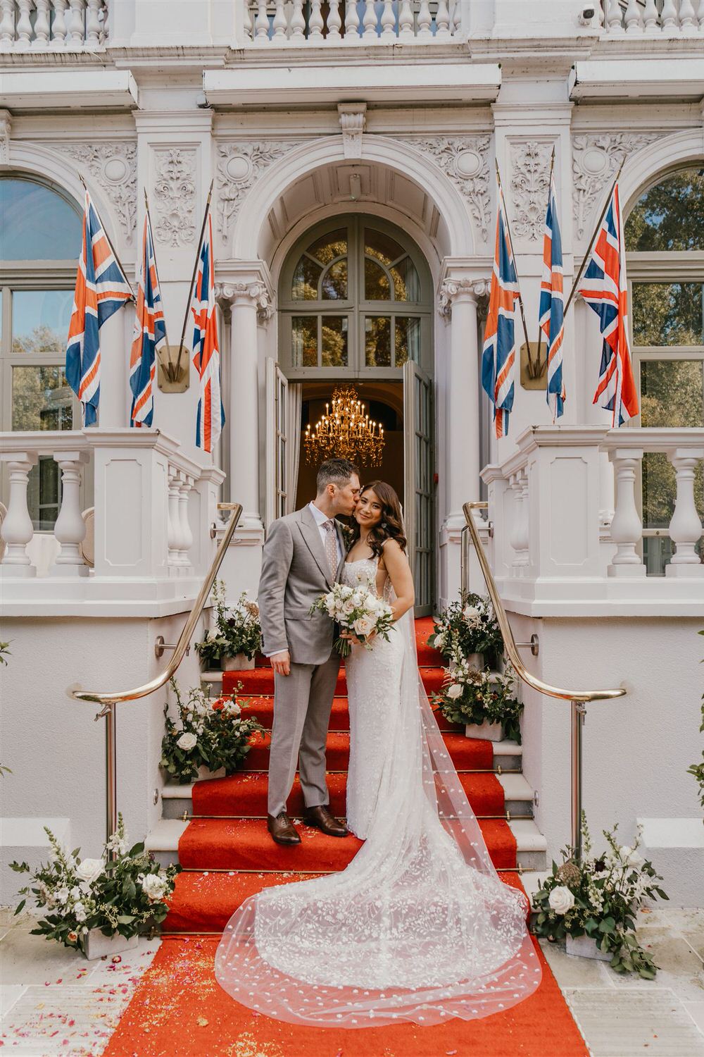 couple portrait on the steps outside mandarin oriental hyde park luxury wedding venue in london