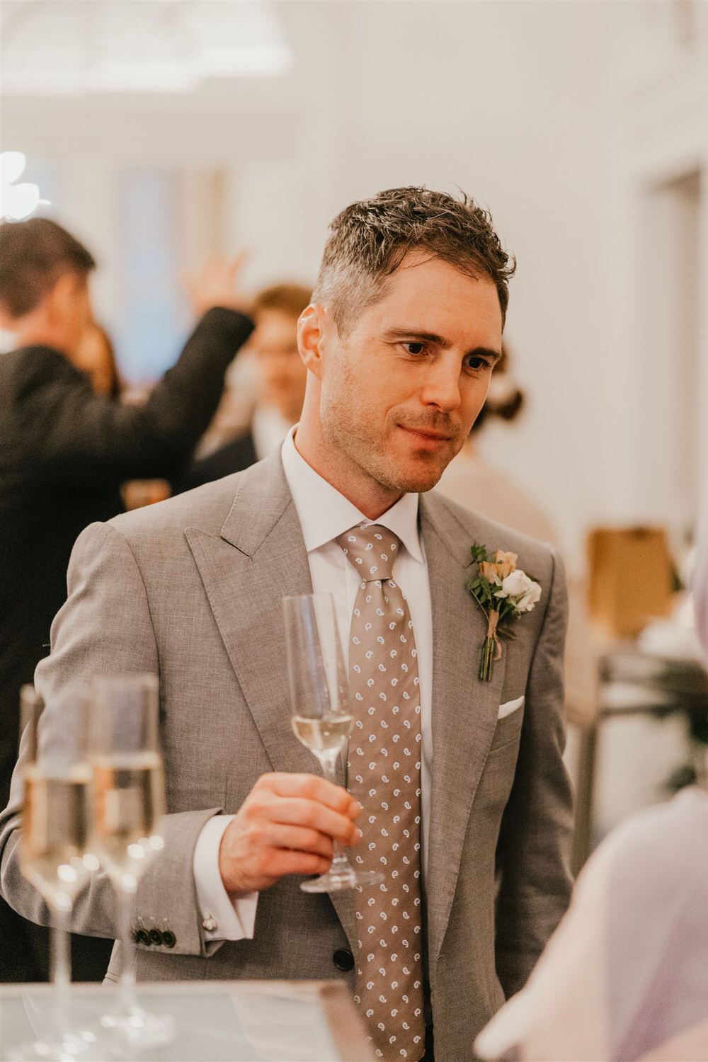 groom during cocktail hour at intimate mandarin oriental wedding london