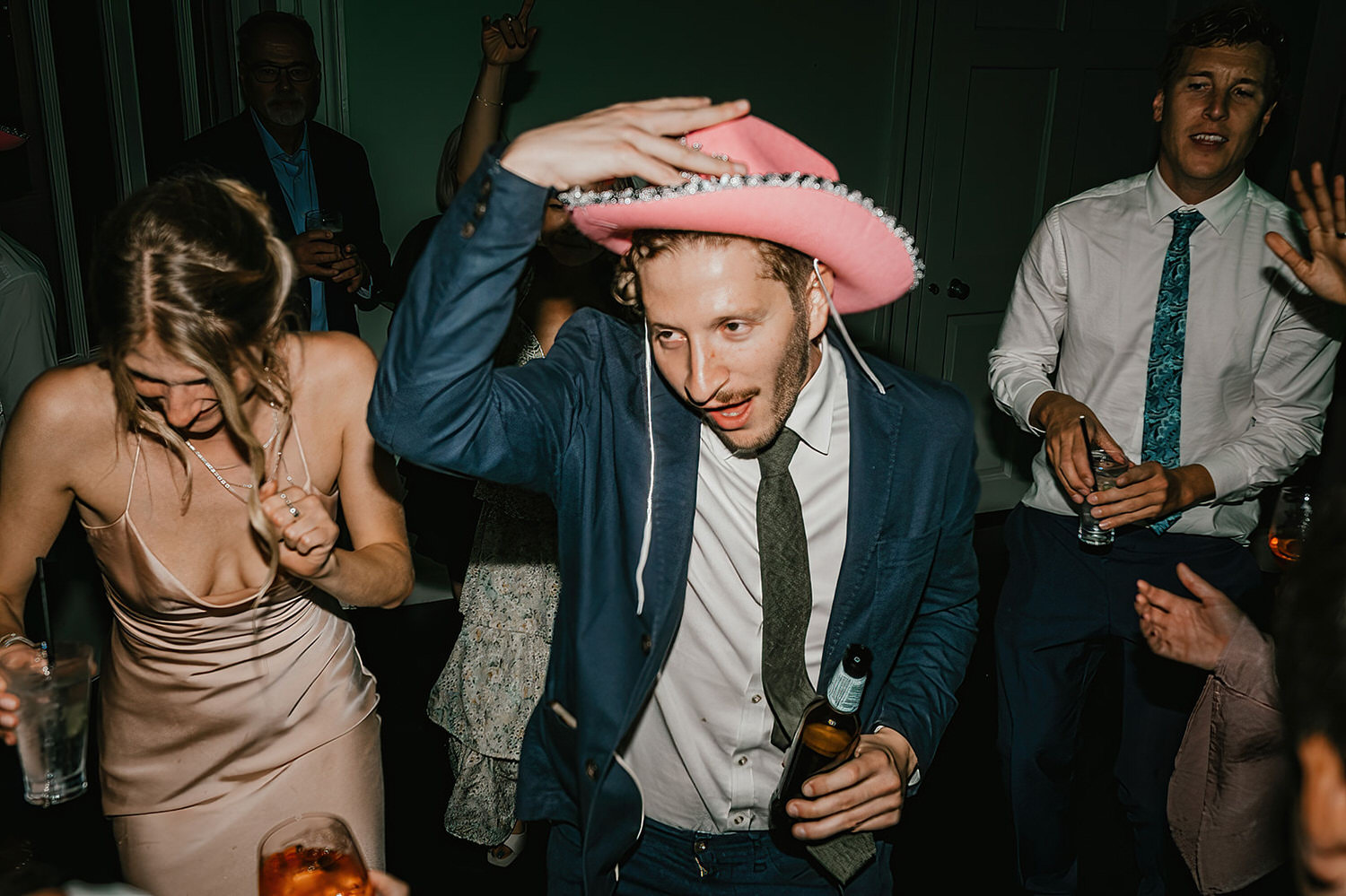 wedding guest wearing pink cowboy hat on the dance floor at morden hall wedding in london