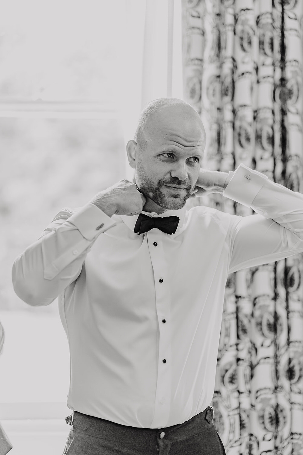 black and white photo of groom getting ready at morden hall wedding groom prep