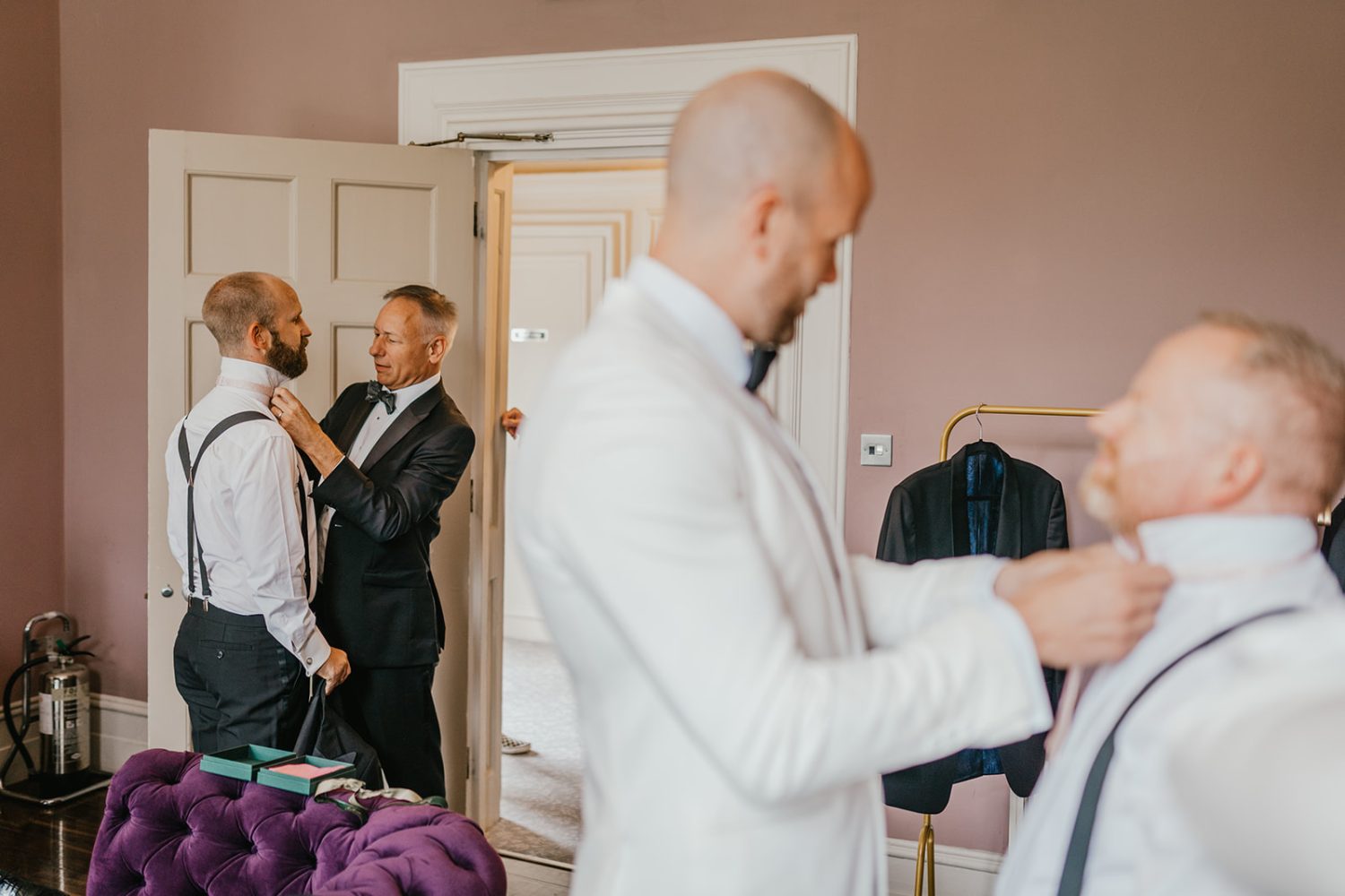 groom and groomsmen get ready at morden hall wedding groom prep