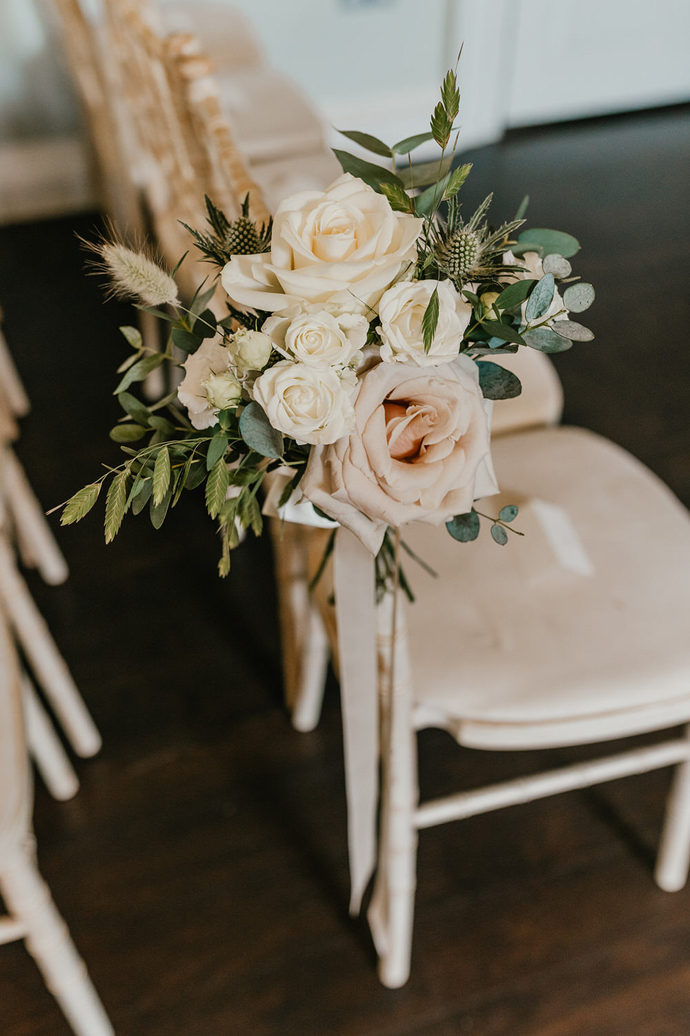 flowers on chair in morden hall wedding ceremony room