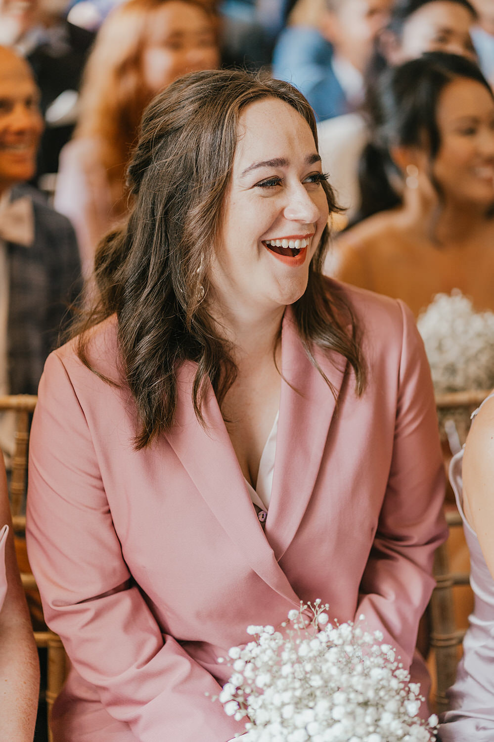 bridesmaid laughs during wedding ceremony at morden hall in london