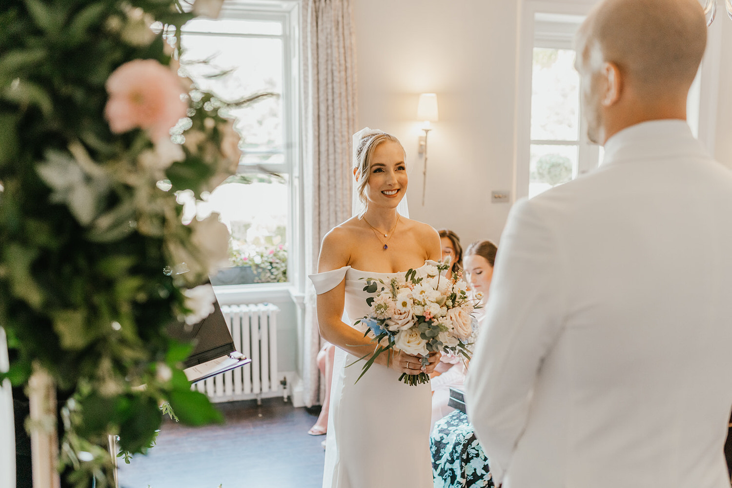 bride smiling during wedding ceremony at morden hall in london
