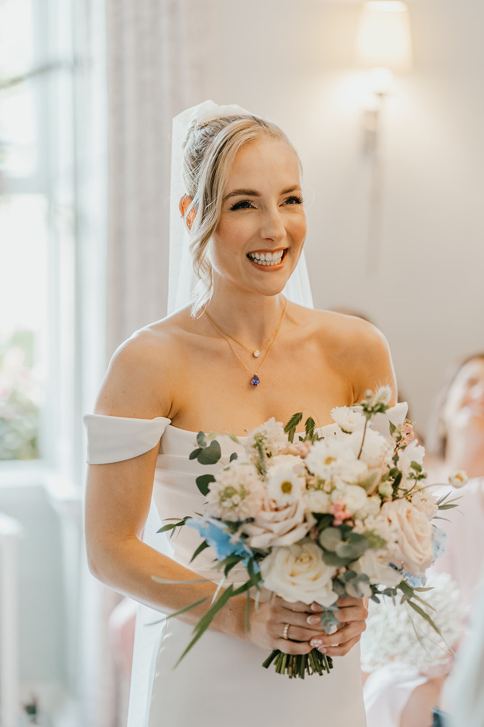 bride smiles during wedding ceremony at morden hall in london