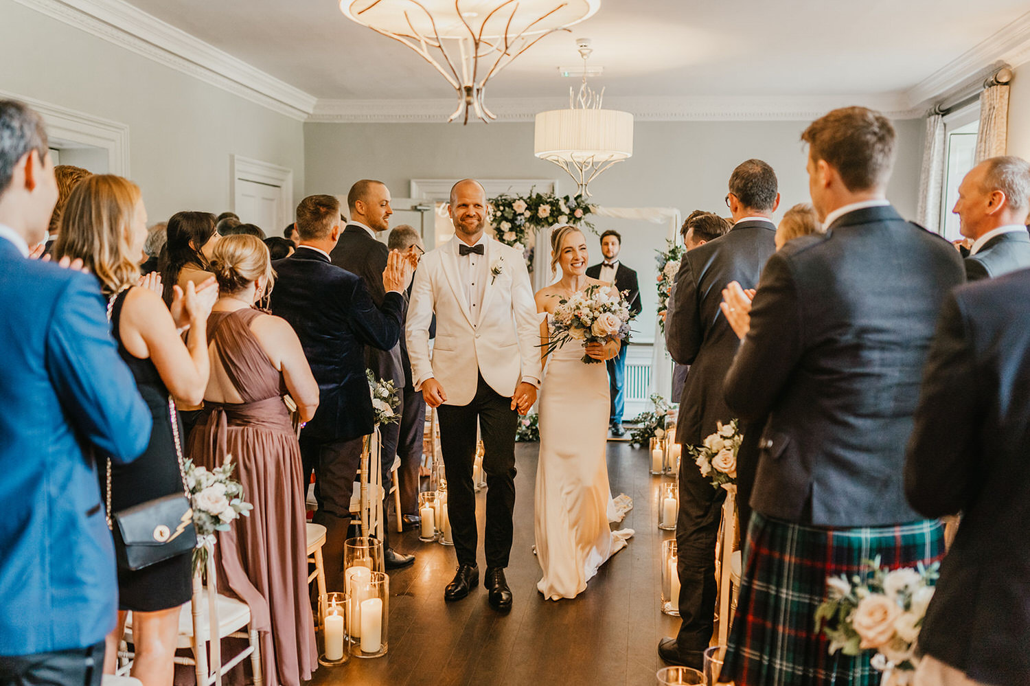 bride and groom walk back down the aisle together after london wedding ceremony at morden hall