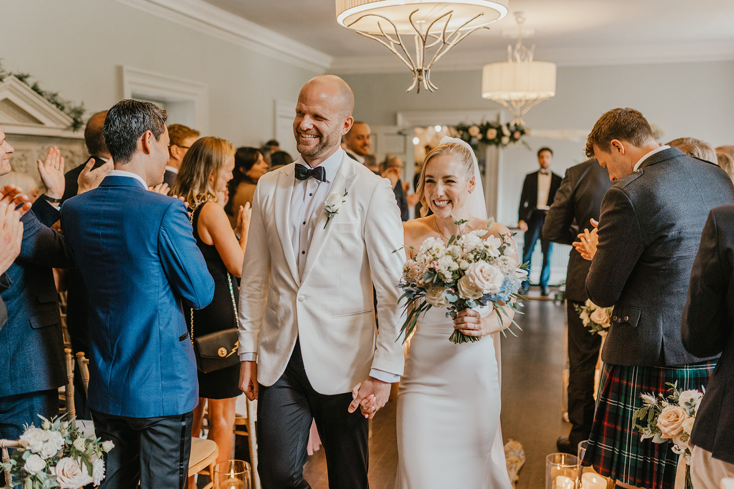 bride and groom walk back down the aisle together after london wedding ceremony at morden hall