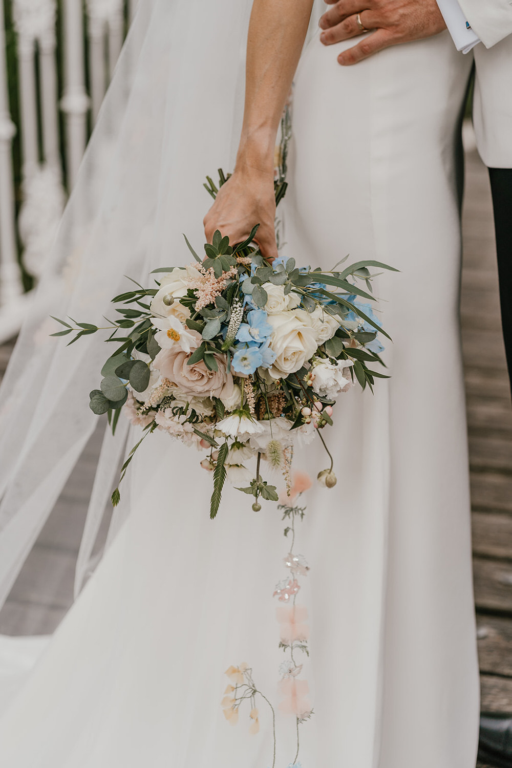 bride holding a bouquet of spring colours