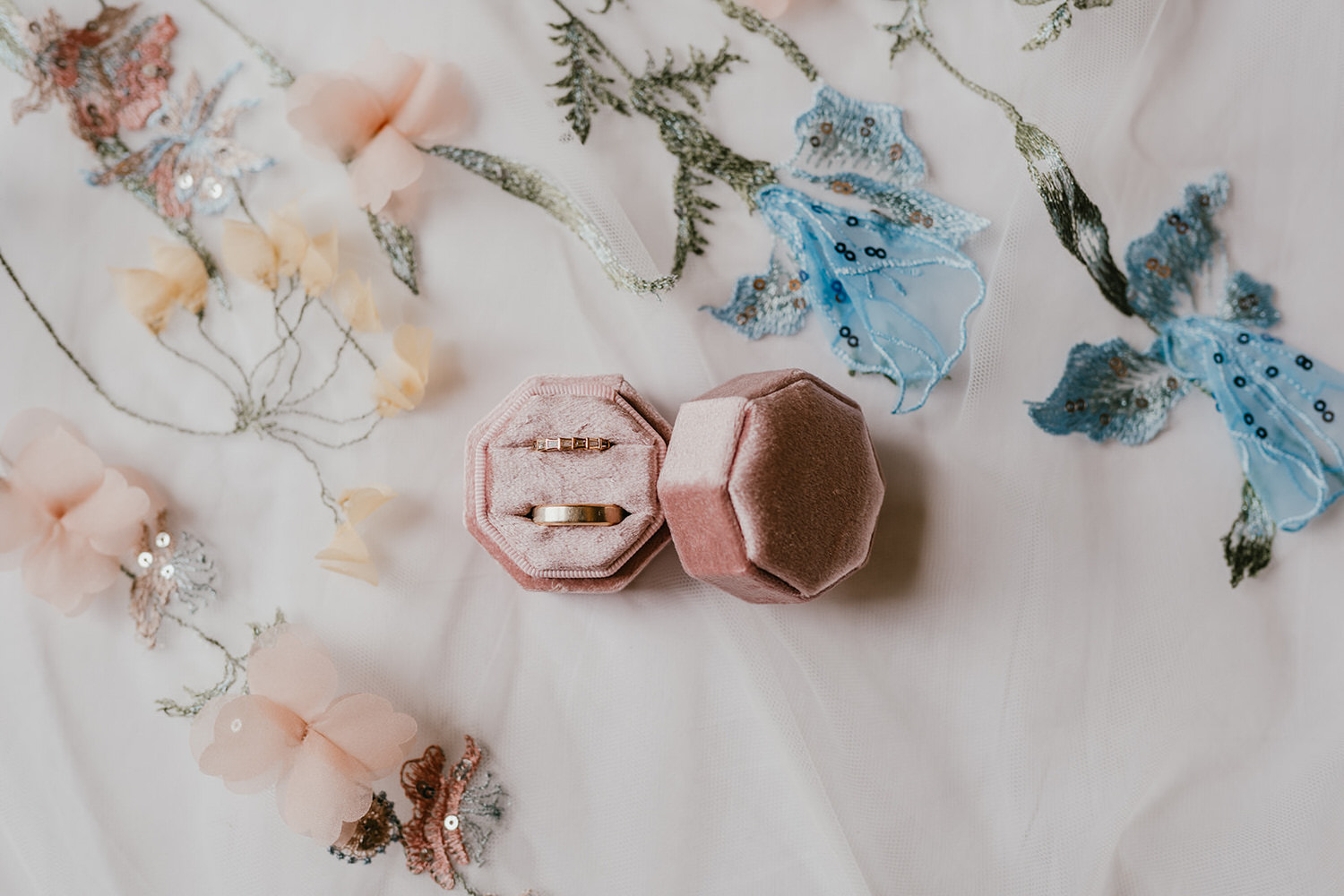 morden hall wedding bridal prep details with rings in pink box sitting on a floral veil