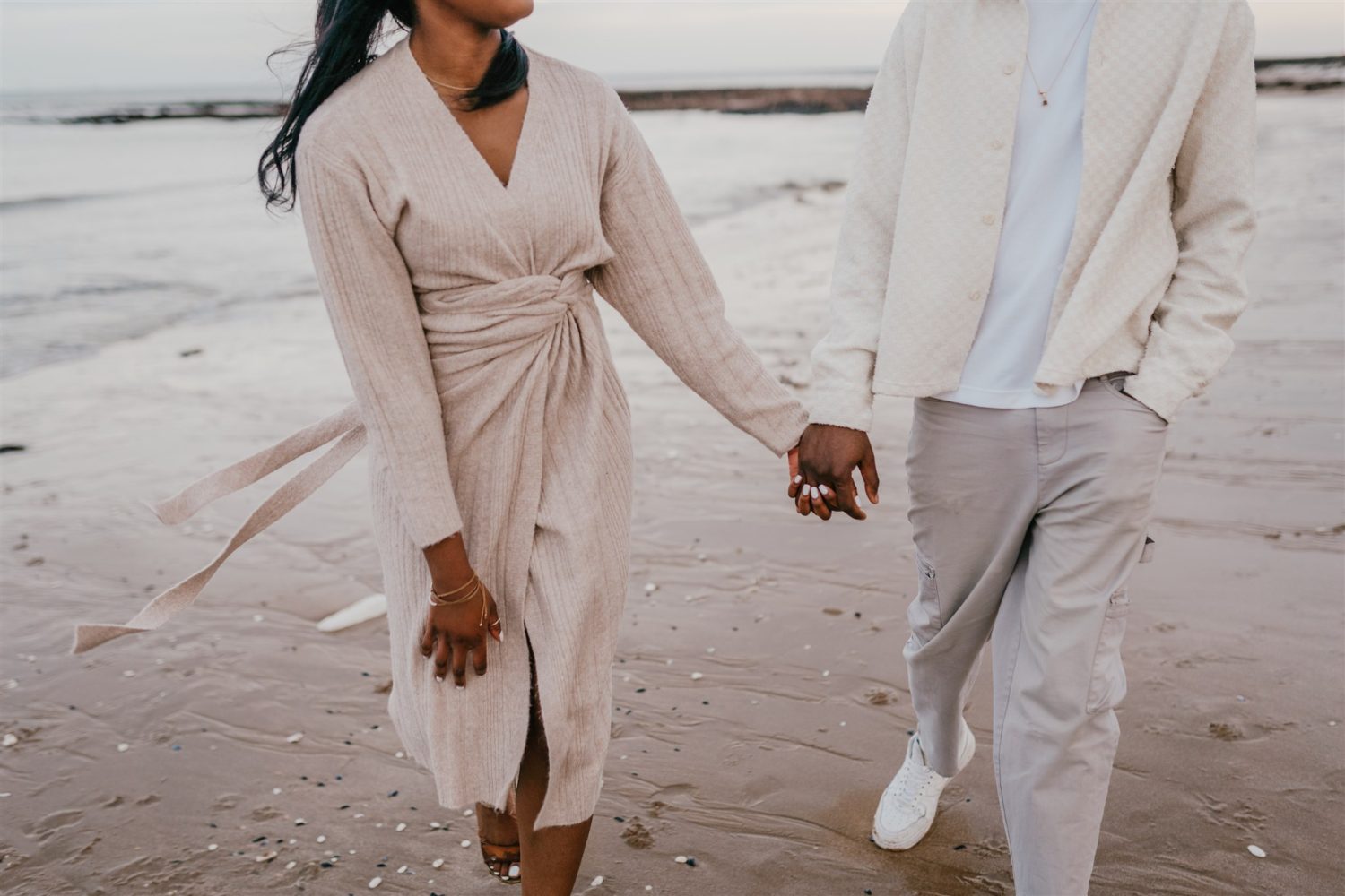 couple holding hands on the beach at botany bay couple shoot in kent