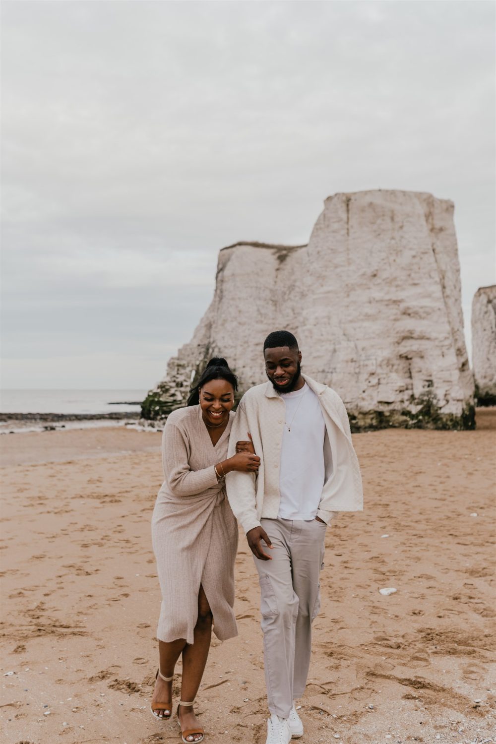 couple walking on the beach at botany bay in kent