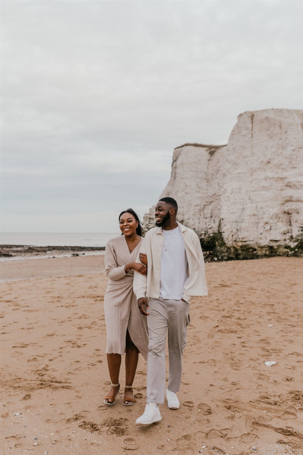 couple walking on the beach at botany bay in kent