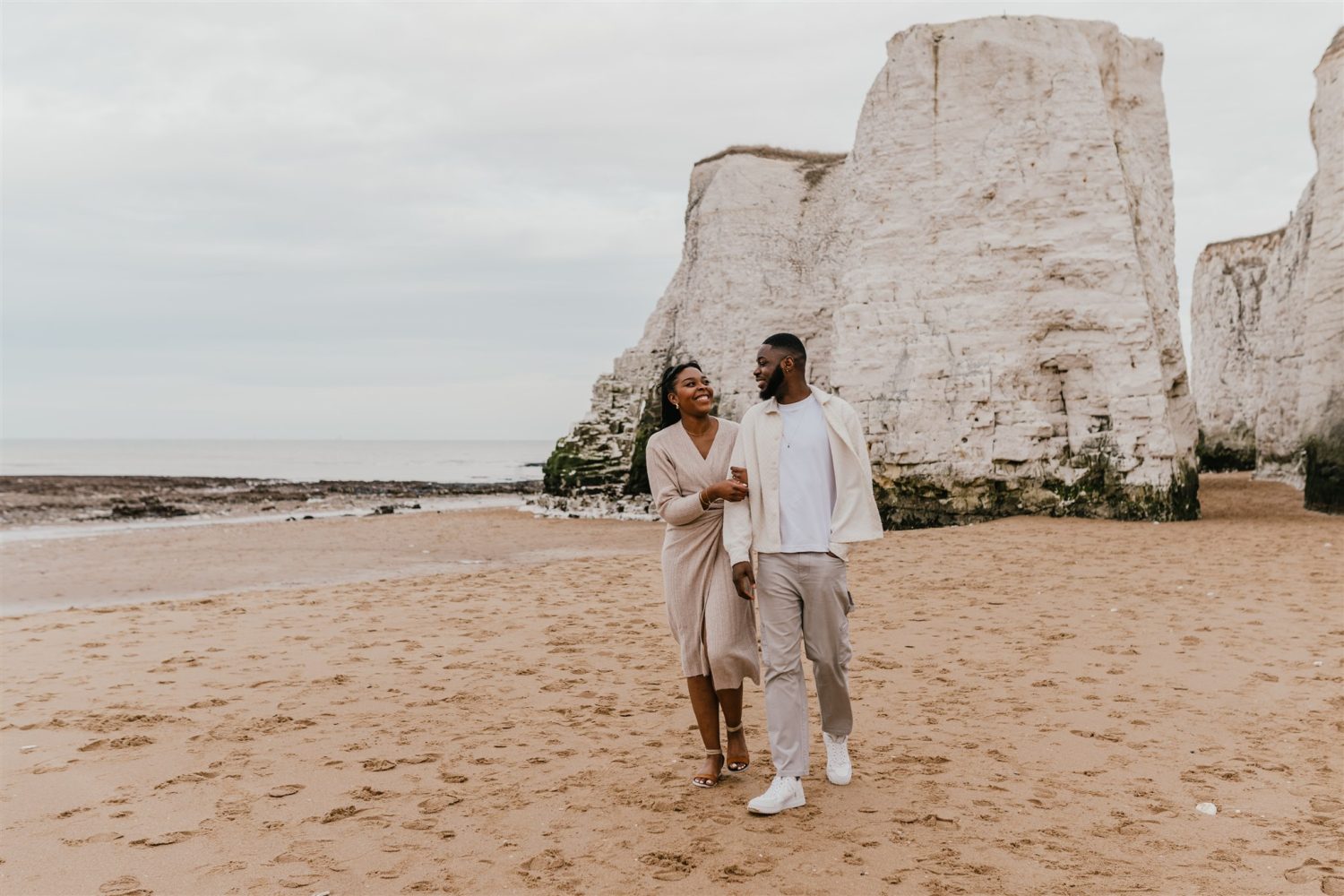 couple walking on the beach at botany bay in kent