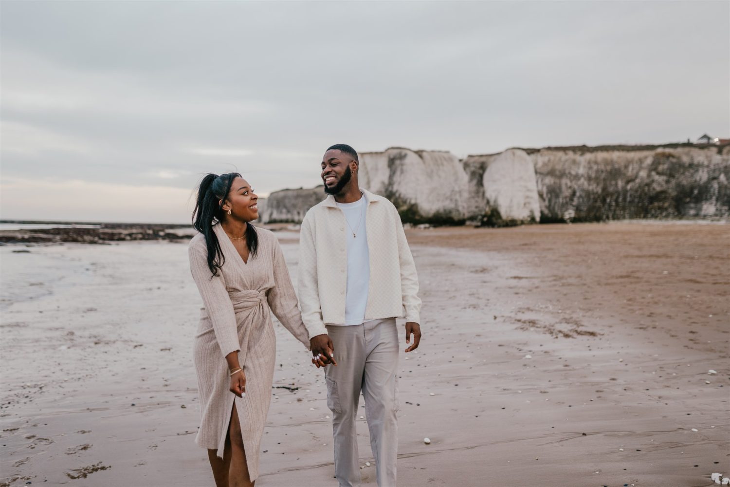 couple holding hands on the beach at botany bay couple shoot in kent