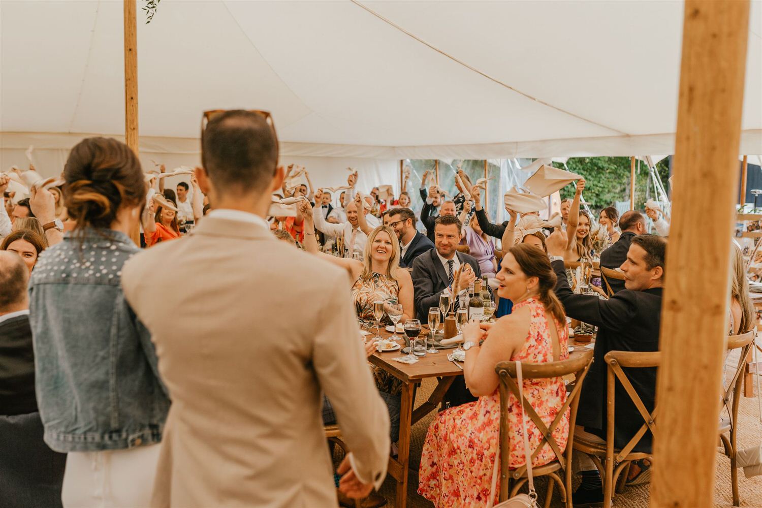 guests waving napkins during bride and groom entrance at kent wedding