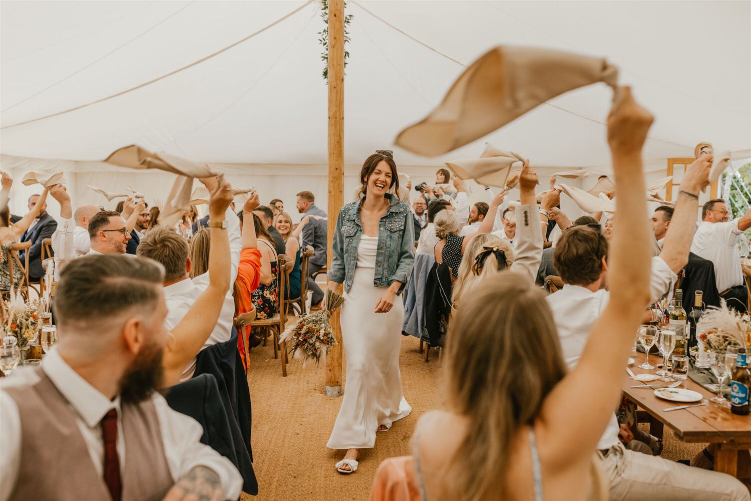 guests waving napkins during bride and groom entrance at kent wedding