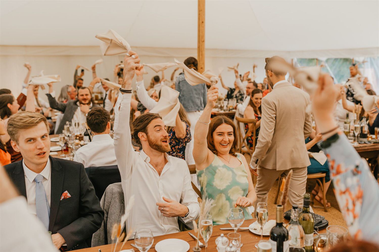 guests waving napkins during bride and groom entrance at kent wedding