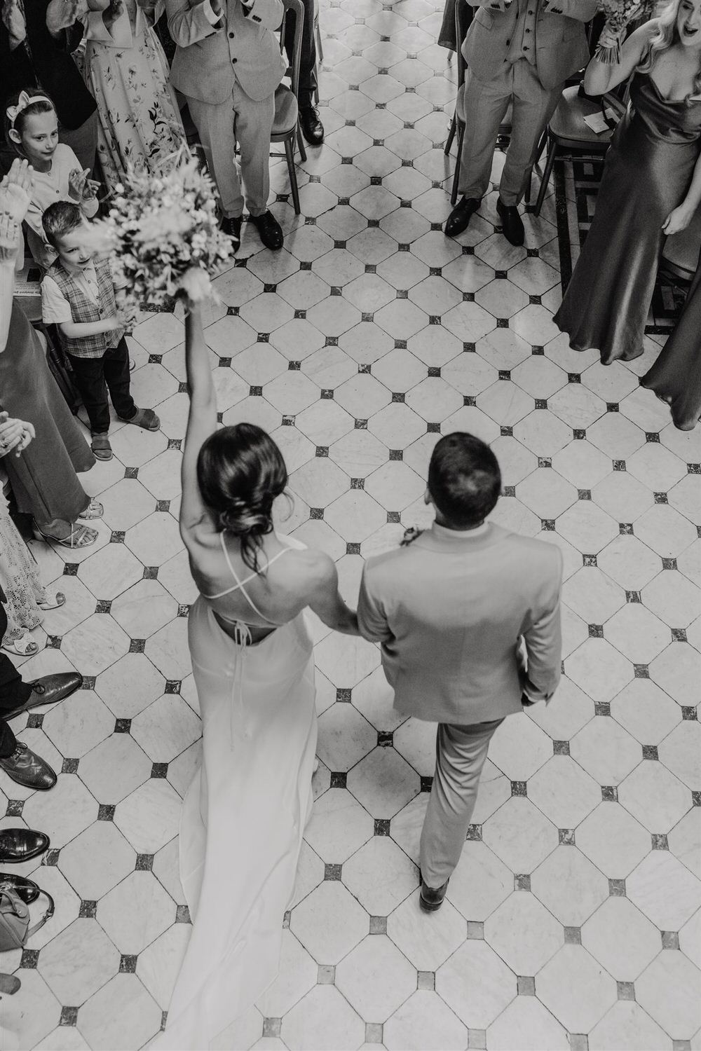 black and white photo of bride and groom as they leave wedding ceremony at mount ephraim
